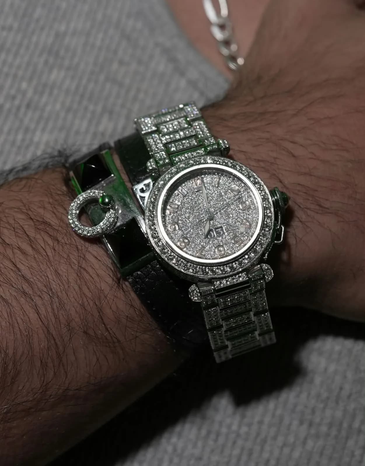Close-up of a stone-set Mozafarian wristwatch and bracelet