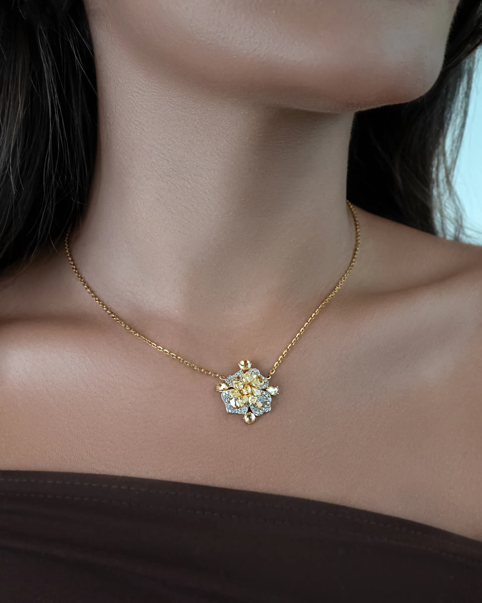 A Mozafarian pendant worn against softly lit skin